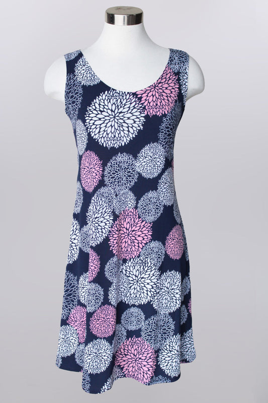 Pull over sleeveless knee length multi print dress with scoop neck.